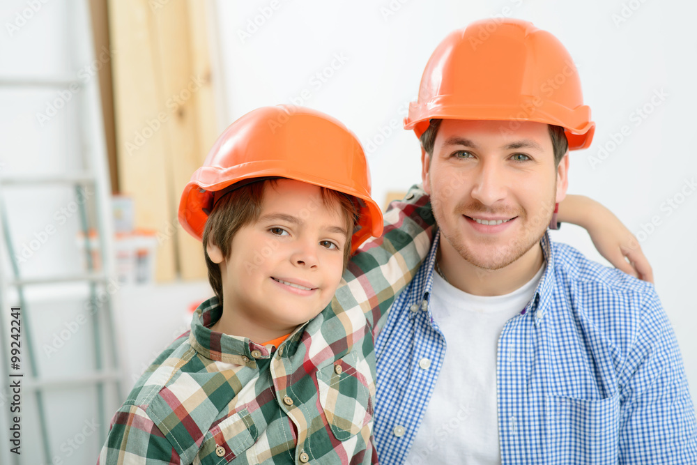 Happy father and son doing renovation Happy father and son doing renovation