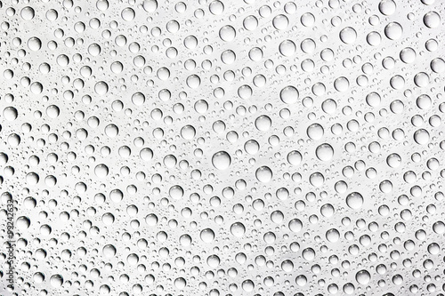 Water drops on transparent glass background.