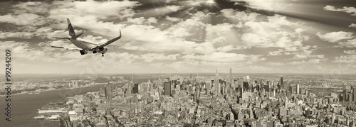Photography Black and white view of airplane over New York City. Tourism con