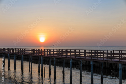 Sunrise in the morning with the wooden bridge view in the sea