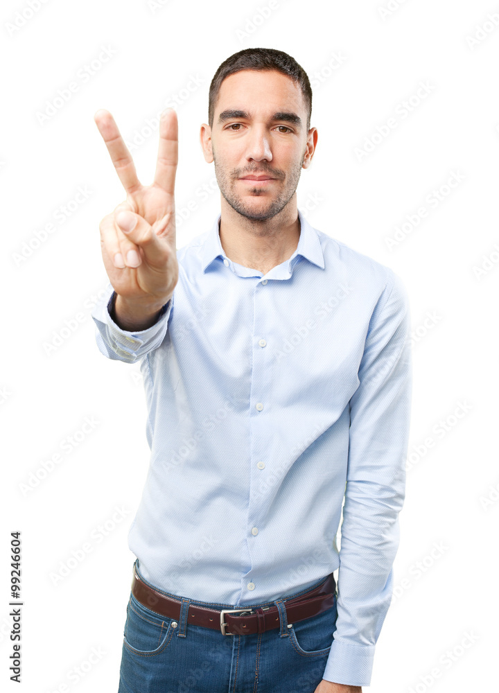 Fototapeta premium Young man with a gesture of victory