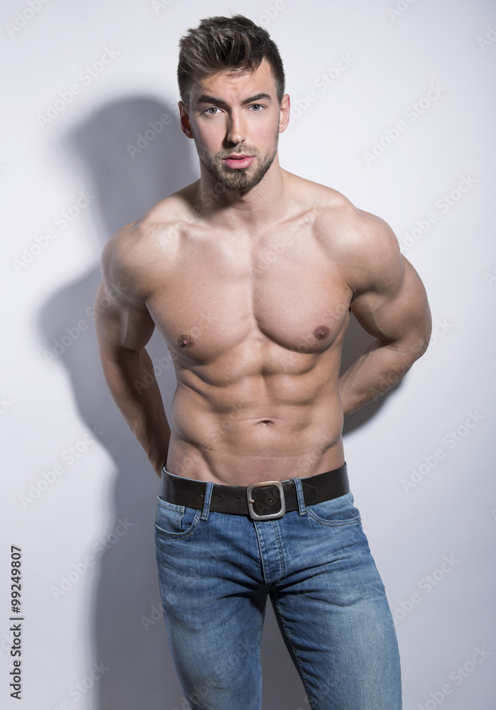 handsome young bodybuilder with toned body posing shirtless handsome young bodybuilder with toned body posing shirtless