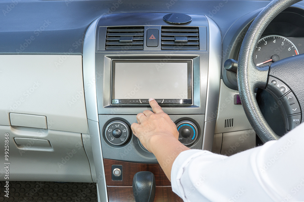 female hand pushing the power button to turn on the car radio female hand pushing the power button to turn on the car radio
