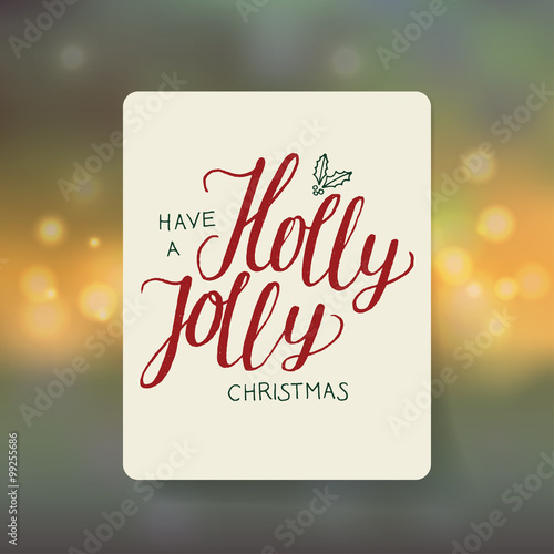 holly jolly handwriting note. bokeh background.