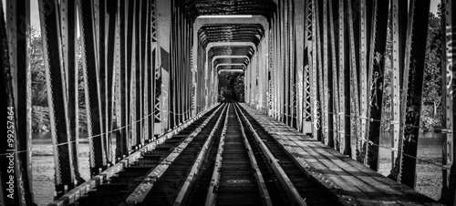Railway bridge and tracks - single point perspective. Black and white view down the tracks on an old railway bridge from yesteryear.