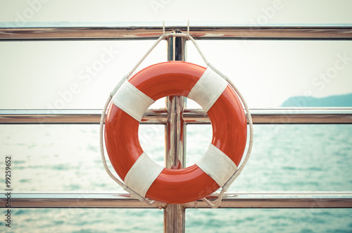 Vintage style photo of life preserver attached to the cruise shi