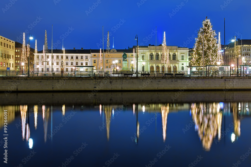 Gustaf Adolf's square in Gothenburg in the evening, decorated for Christmas and reflecting in the water of the main harbour canal, Sweden