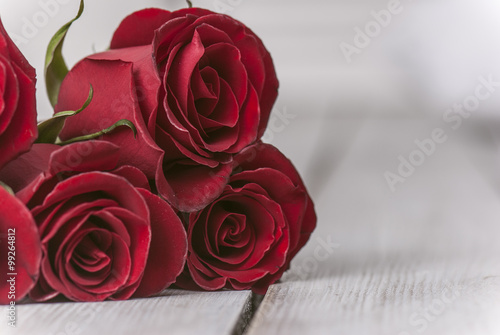 Red roses and a heart on wooden board  Valentines Day background  wedding day