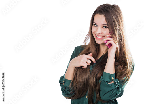 beautiful young girl on a white background is a pink cell phone telefonom.Govorit. Smiles. Surprised. photo