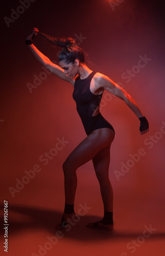sexy acrobatic fitness woman on red