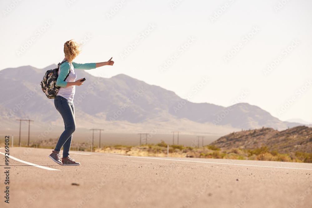 Woman On Vacation Hitchhiking Along Country Road Woman On Vacation Hitchhiking Along Country Road