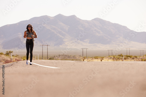 Woman On Vacation Hitchhiking Along Country Road © Monkey Business