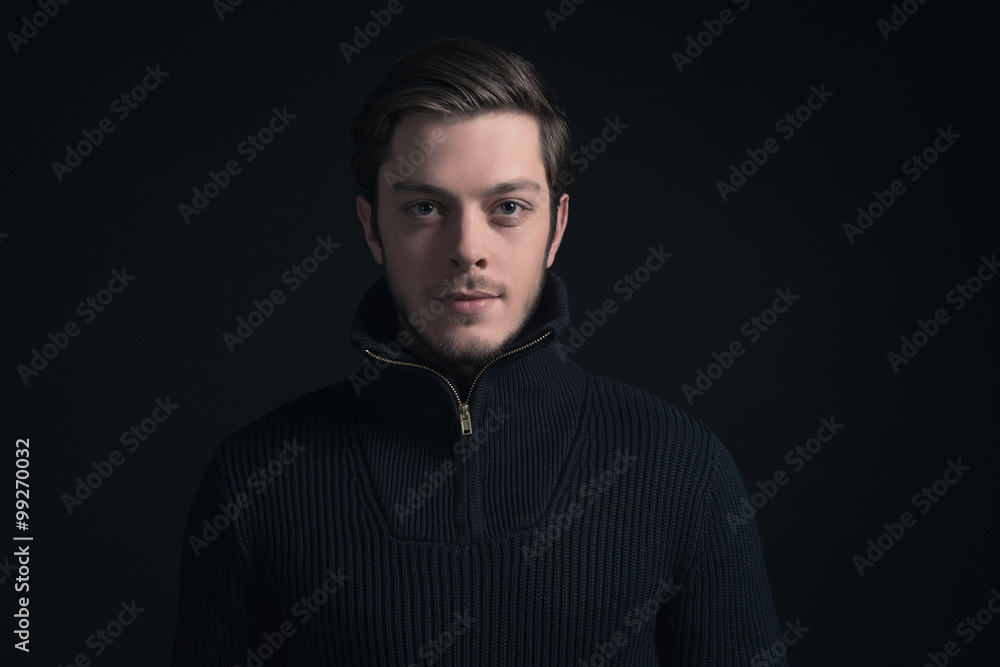 Obraz premium Man with stubbly beard wearing dark blue turtleneck.
