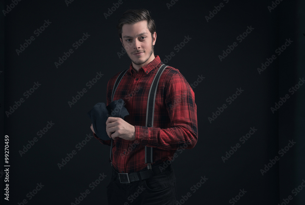 Fashionable man in red checkered shirt and braces.