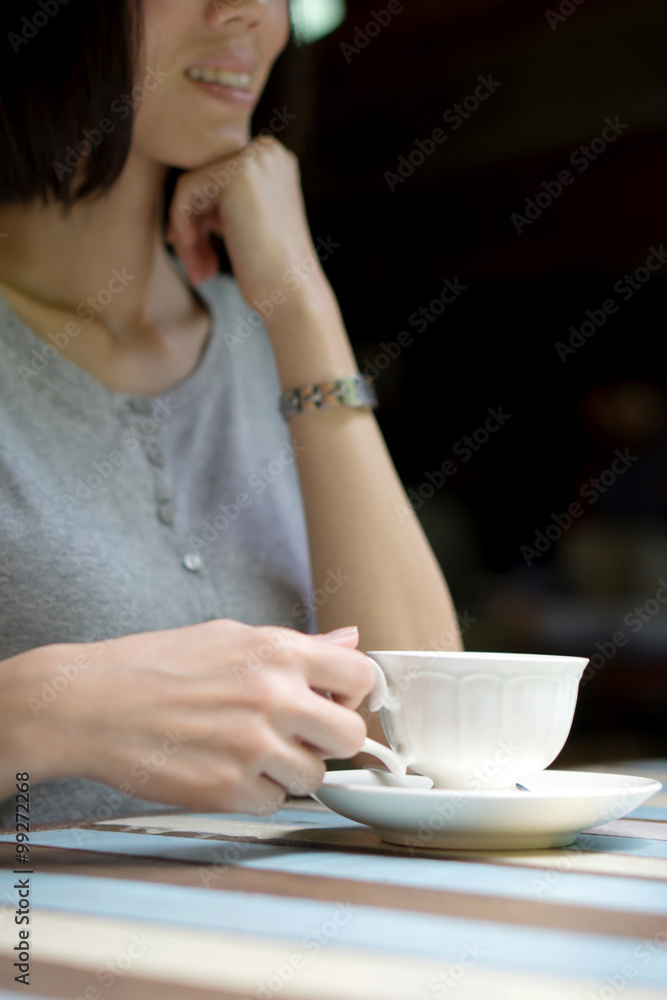 Girl's hands holding a cup of coffee Girl's hands holding a cup of coffee