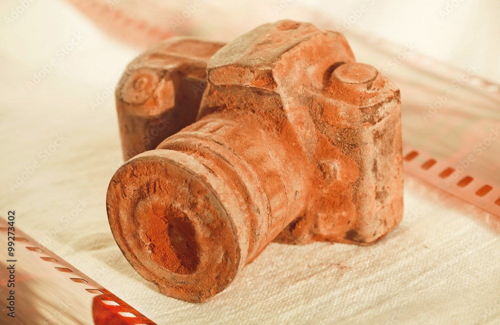 Selective focus nobrand chocolate camera with photo films Selective focus nobrand chocolate camera with photo films