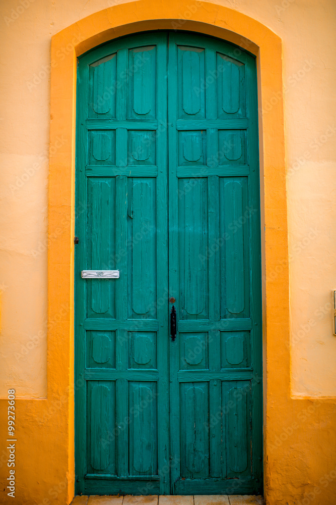 Green door in the yellow wall 