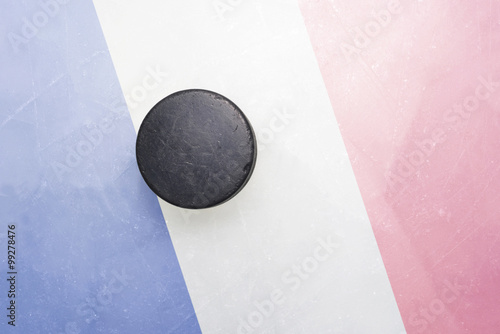 old hockey puck is on the ice with france flag