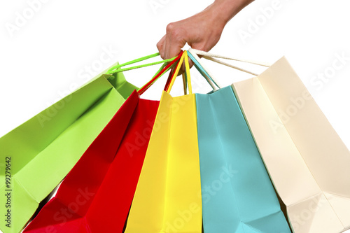Hand holding colorful shopping bags - isolated