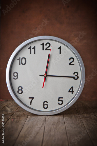 white clock on a table with old steel background,vintage style