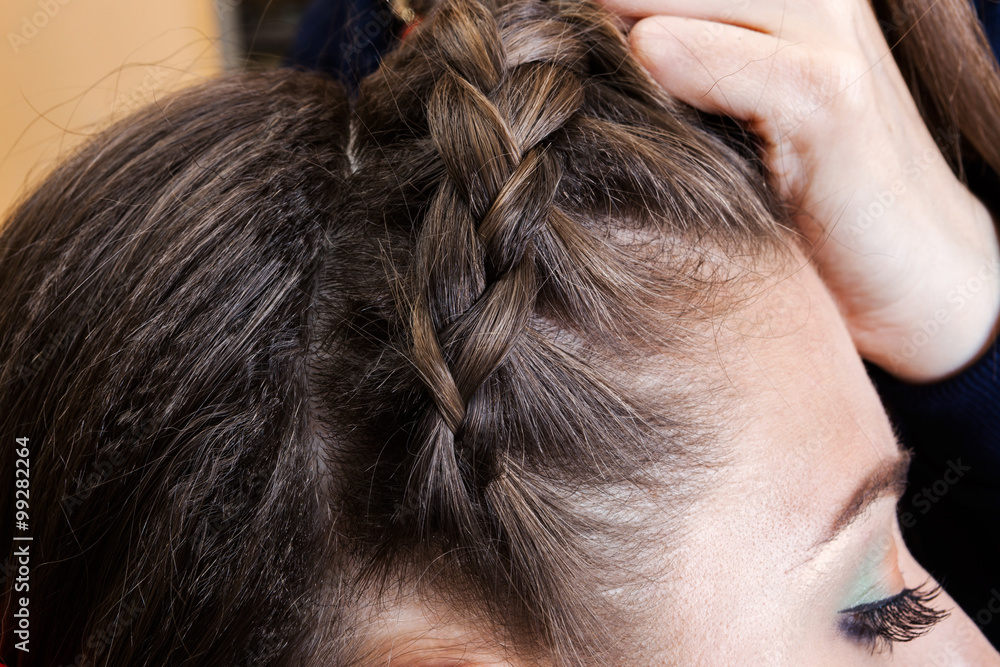 Naklejka premium weaving braids a brunette