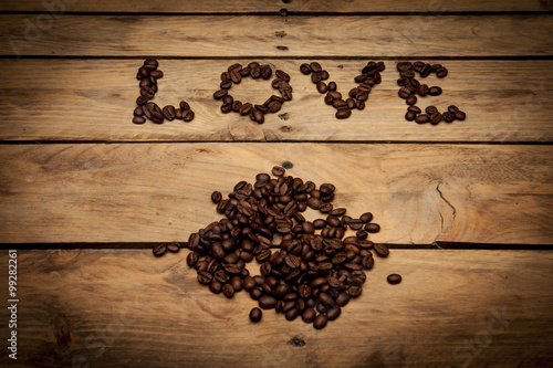  Inscription love made from coffee beans on wooden surface. dife photo