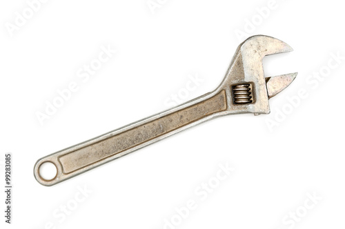 Old adjustable wrench on white background © unclepodger