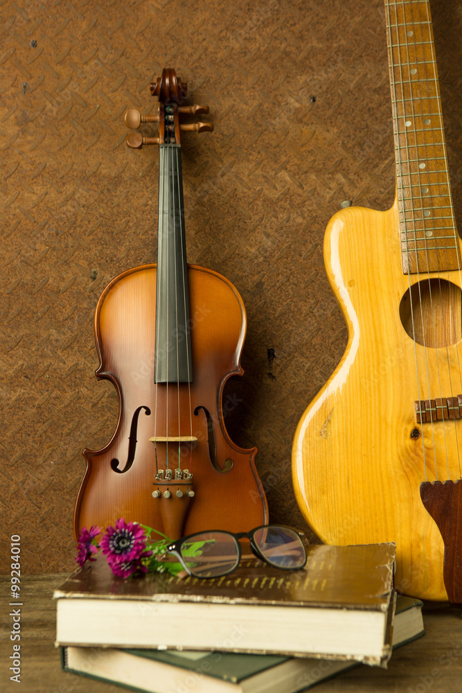 violin and guitar in vintage style on old steel  background