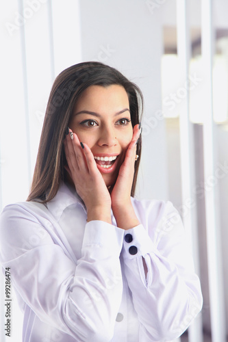 Portrait of beautiful surprised young businesswoman