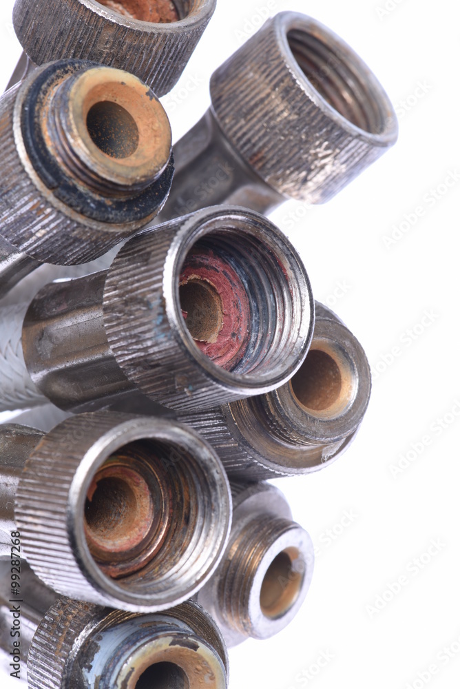 Old plumbing hose pipes isolated on white background