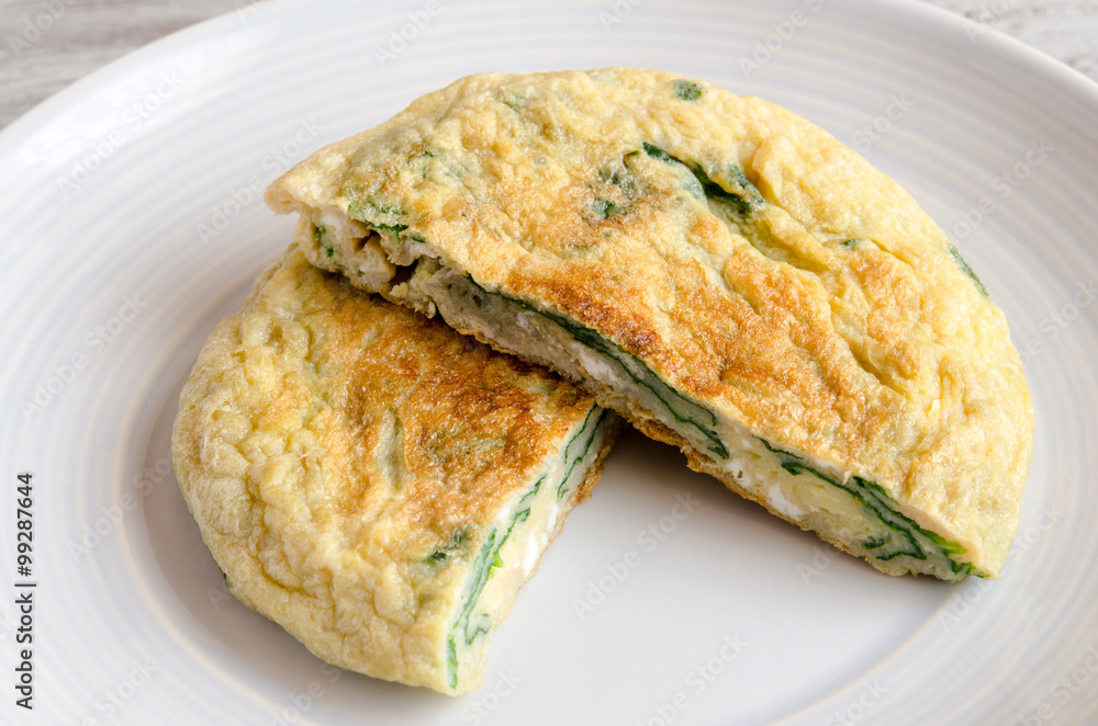 Omelet with spinach on plate Omelet with spinach on plate