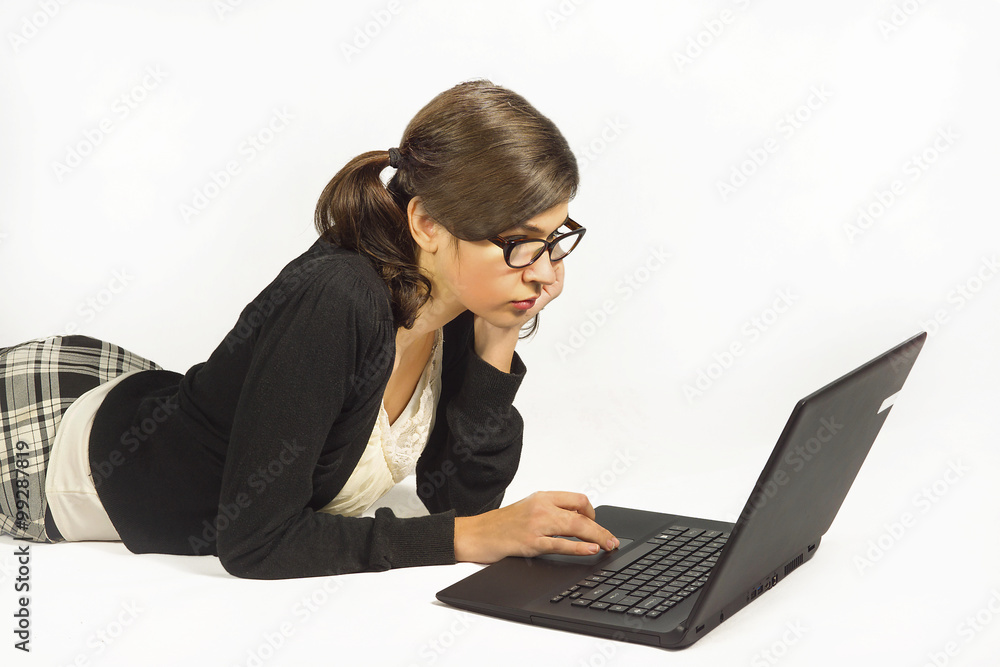 Young pretty girl lying on the ground and laptop Young pretty girl lying on the ground and laptop