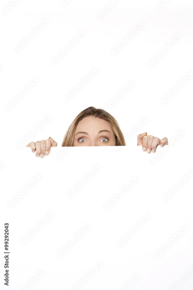 Woman hiding behind white board Woman hiding behind white board