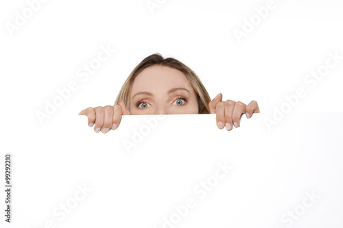 Behind a white board - Woman hiding or peeking behind a white sign
