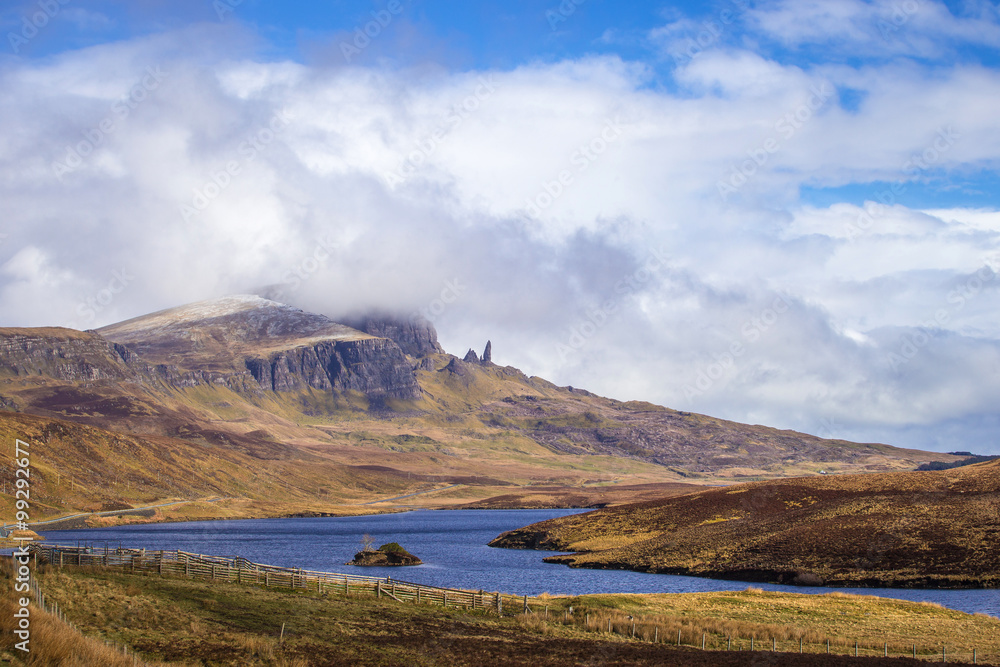 The famous Old Man of Storr on the Isle of Skye on a sunny spring day with blue sky and clouds - Scotland, UK