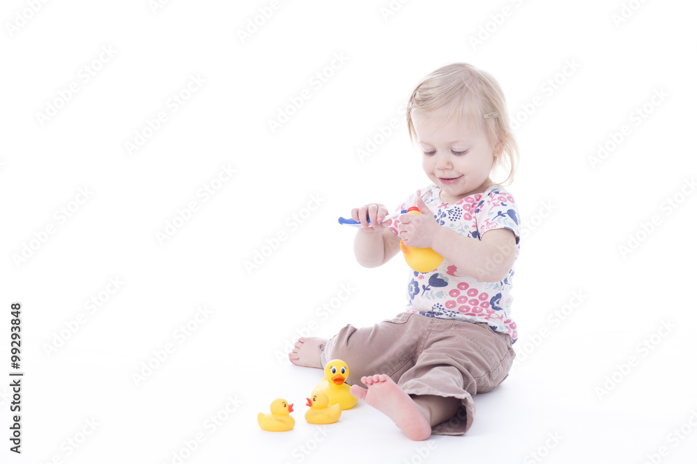 toddler girl brushing duck teeth toddler girl brushing duck teeth
