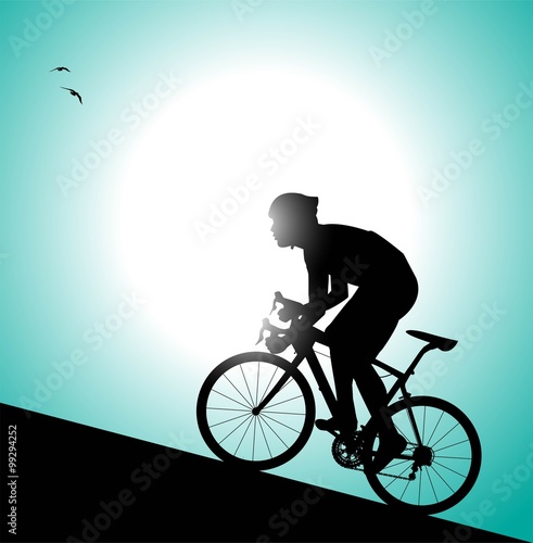 silhouette di ciclista che pedala in salita photo