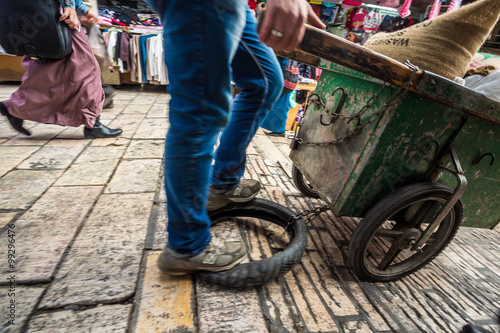Street seller distributing goods on narrow streets of Jerusalem.