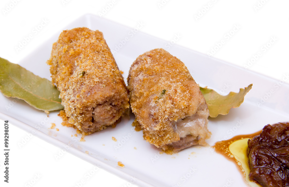 Breaded meat rolls on the tray on white background seen up close Breaded meat rolls on the tray on white background seen up close
