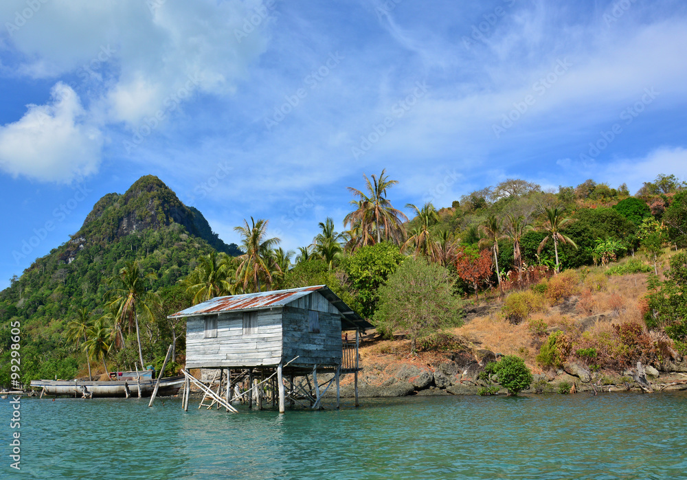 Exotic tropical Island with the Sea Gypsy house, Bodgaya Island, Semporna, Sabah Borneo, Malaysia. The island is the largest island in and forms part of the Tun Sakaran Marine Park. Exotic tropical Island with the Sea Gypsy house, Bodgaya Island, Semporna, Sabah Borneo, Malaysia. The island is the largest island in and forms part of the Tun Sakaran Marine Park.