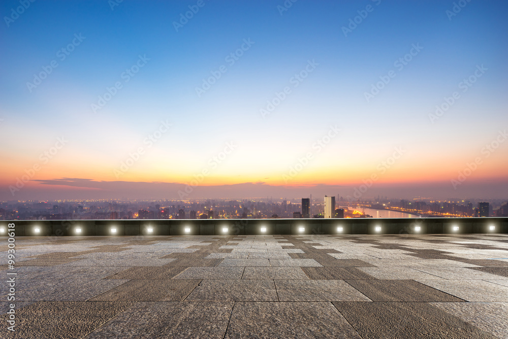 empty floor front of cityscape at sunrise