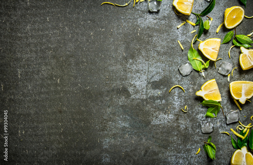 Slices of lemon  ice  leaves on stone table.