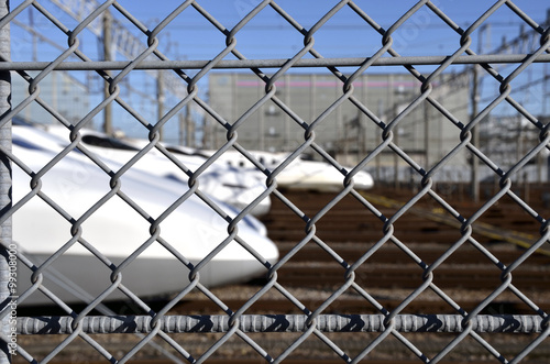 Wire mesh fence enclosing the Shinkansen rail yards 