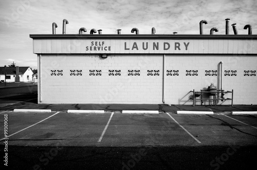 Fotografija aged vintage photo of black and white public laundromat