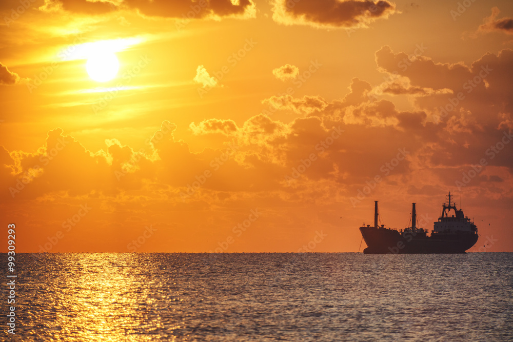 Sailing ship in the sea. Beautiful morning and colorful sunrise.