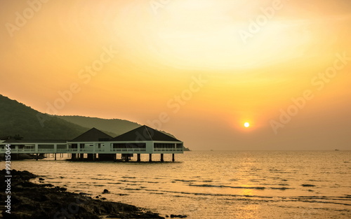 Bungalow near the sea with sunset