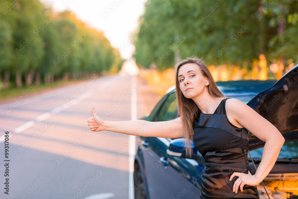 Beautiful business woman near the broken car, hitch-hiking Beautiful business woman near the broken car, hitch-hiking