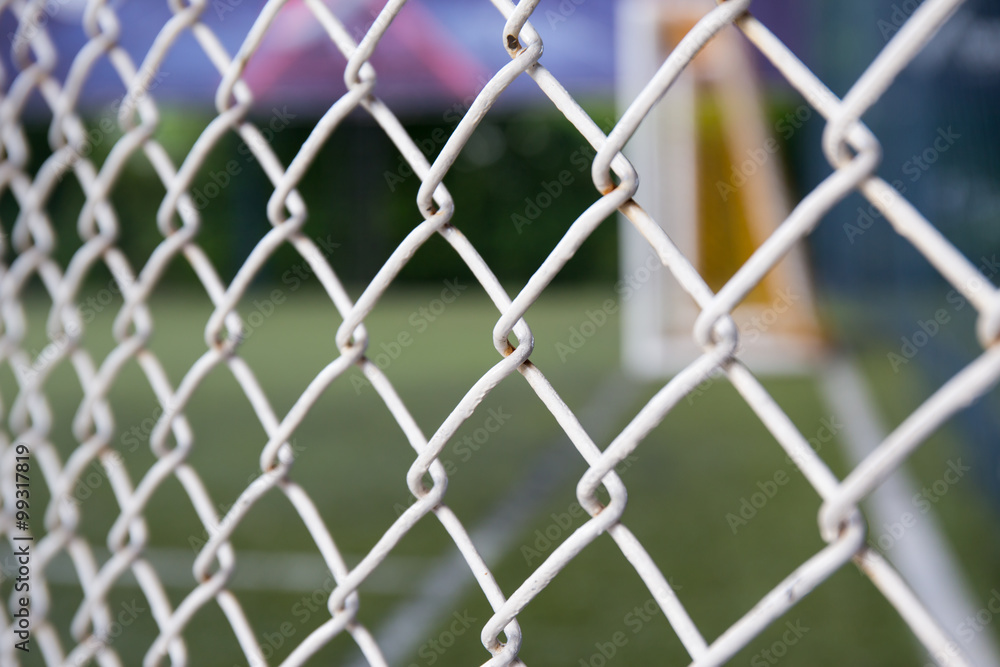 Fototapeta premium white metal grate fence texture and sport field background