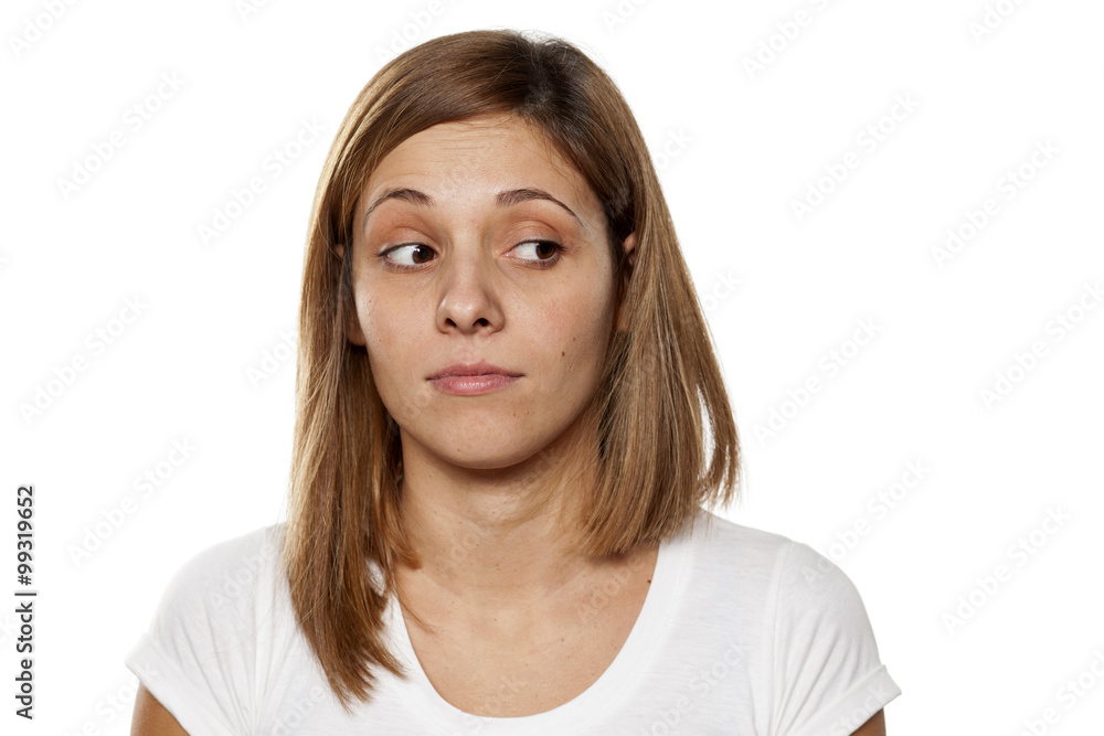 serious young woman looking away with distrust serious young woman looking away with distrust