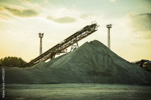 gravel pit with an industrial gravel sorter machinery at sunset